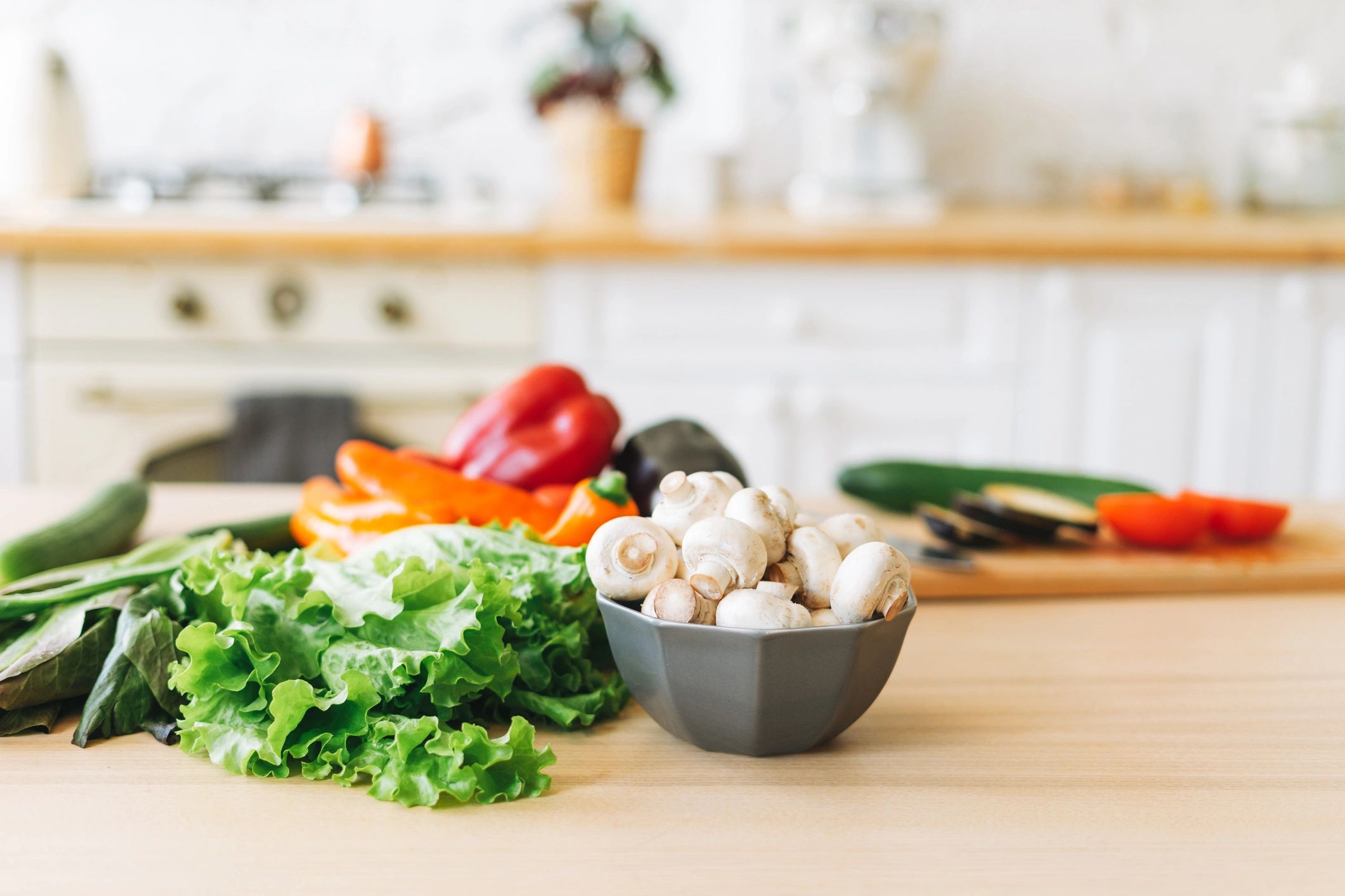 Colorful vegetables and meal prep ingredients on a kitchen table