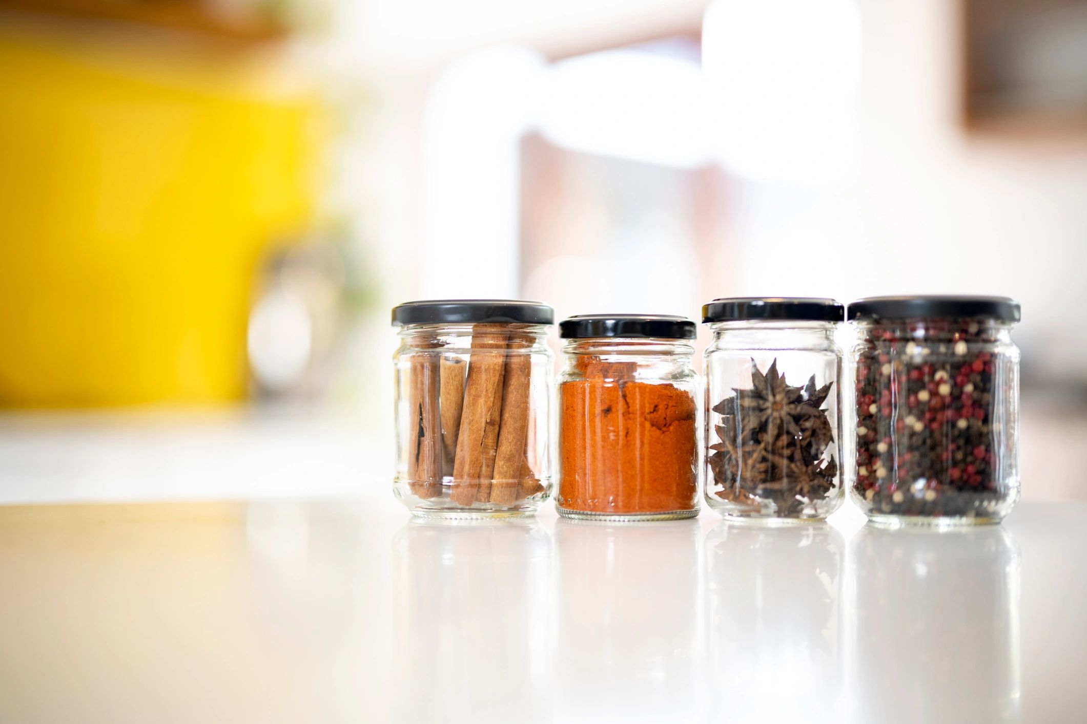 Organized pantry jars and spices on a kitchen counter