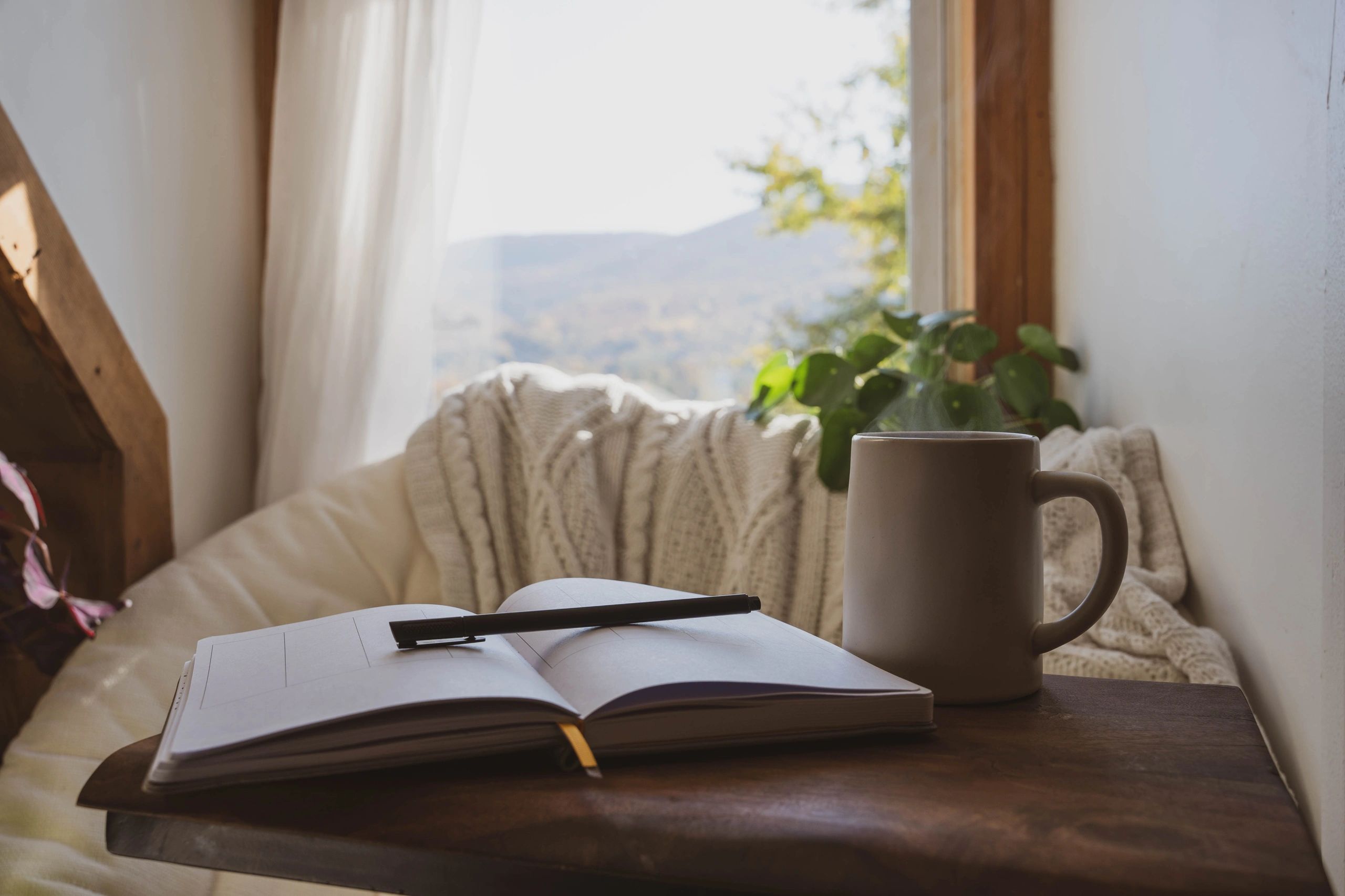 Cozy reading nook with journal and coffee