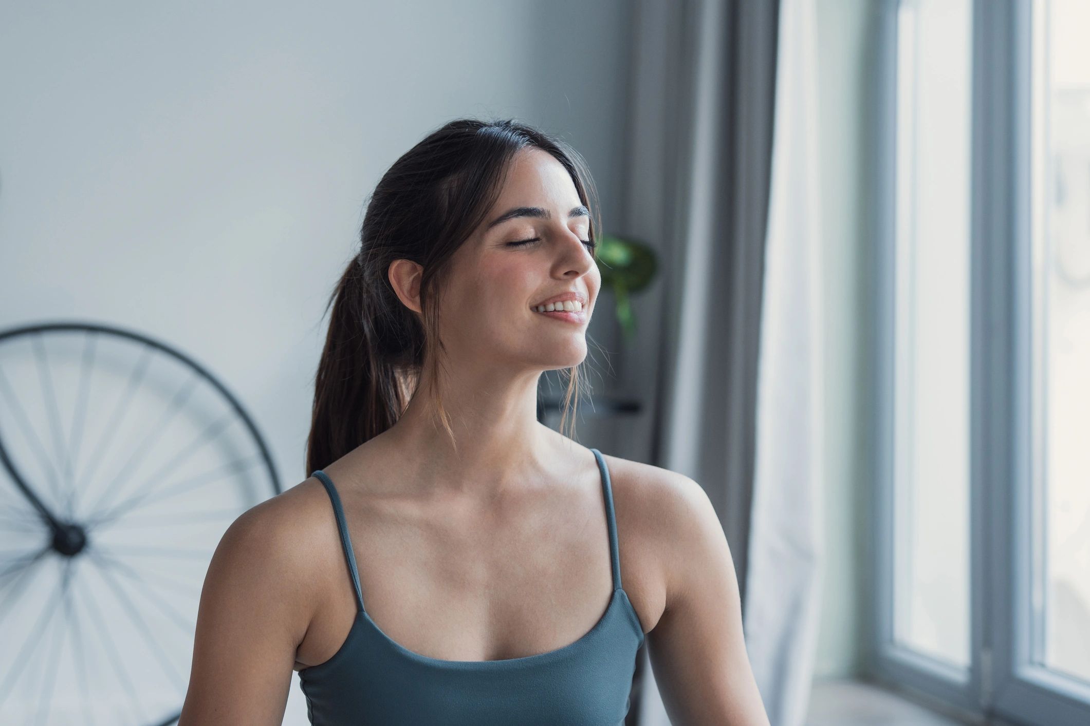 Woman practicing calm breathing in a bright living room